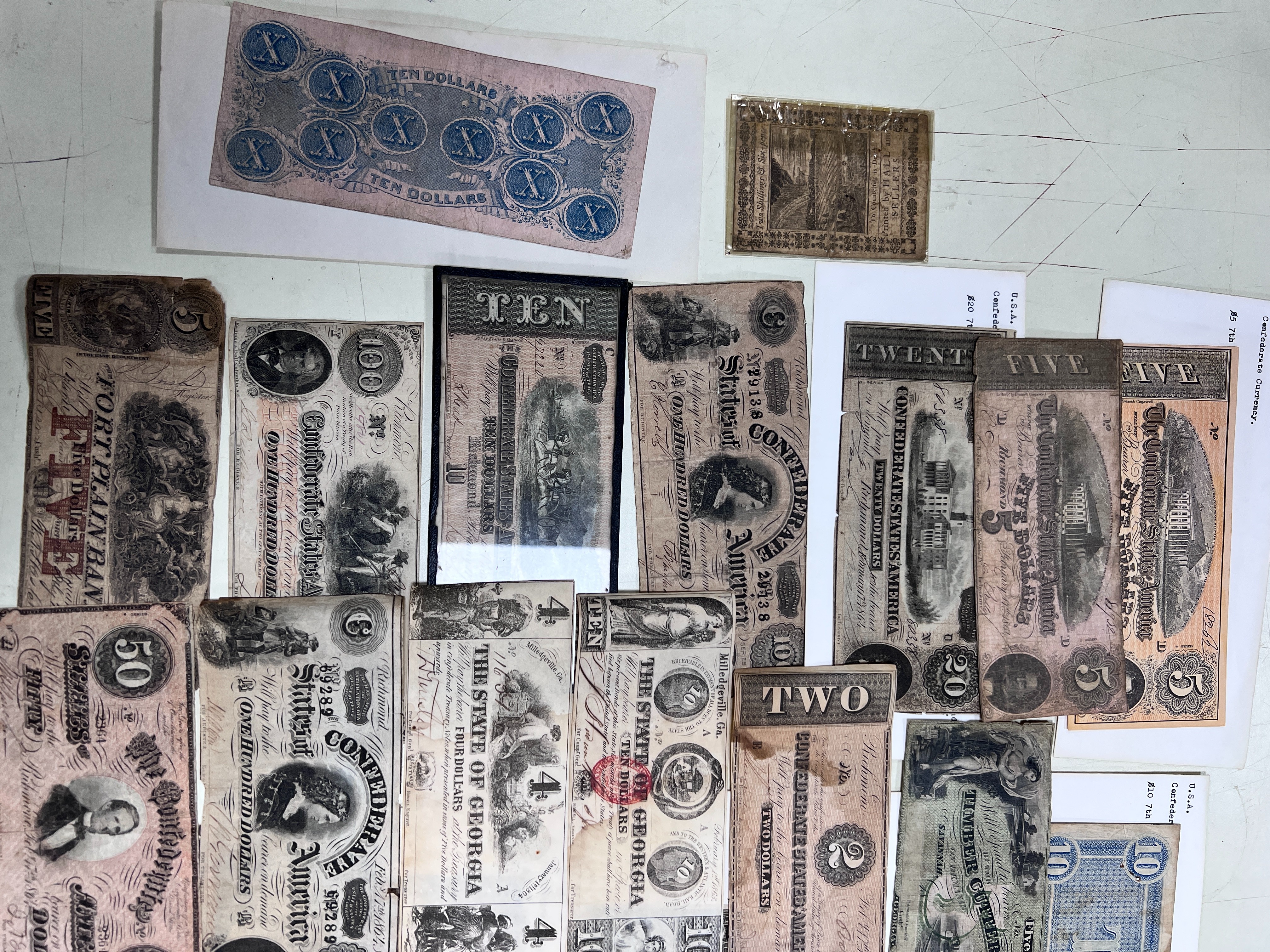 A collection of US Confederate States banknotes, including a confederate states of America $500 seventh issue 17 February 1864, $100 Richmond July 4 1862 x 2 and another 1864, and many others